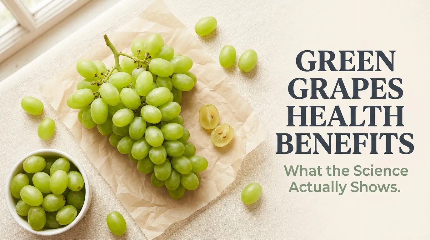 Overhead flat-lay of fresh green grapes with the Green Grapes Health Benefits headline displayed in bold text on a cream background.